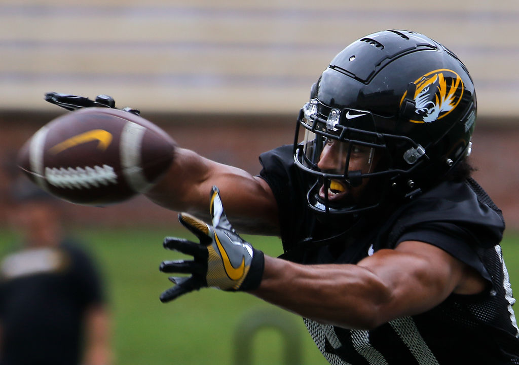 Khalil Oliver stretches to make a catch during a drill